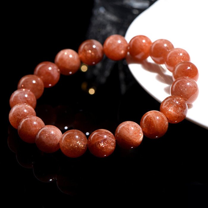 Golden sunstone round bead bracelet for increasing self-confidence.