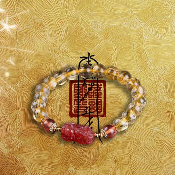Golden rutilated quartz and strawberry quartz pixiu elastic rope bracelet.