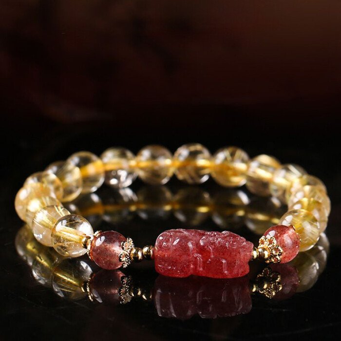 Golden rutilated quartz and strawberry quartz pixiu elastic rope bracelet.