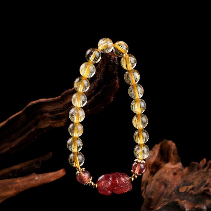 Golden rutilated quartz and strawberry quartz pixiu elastic rope bracelet.