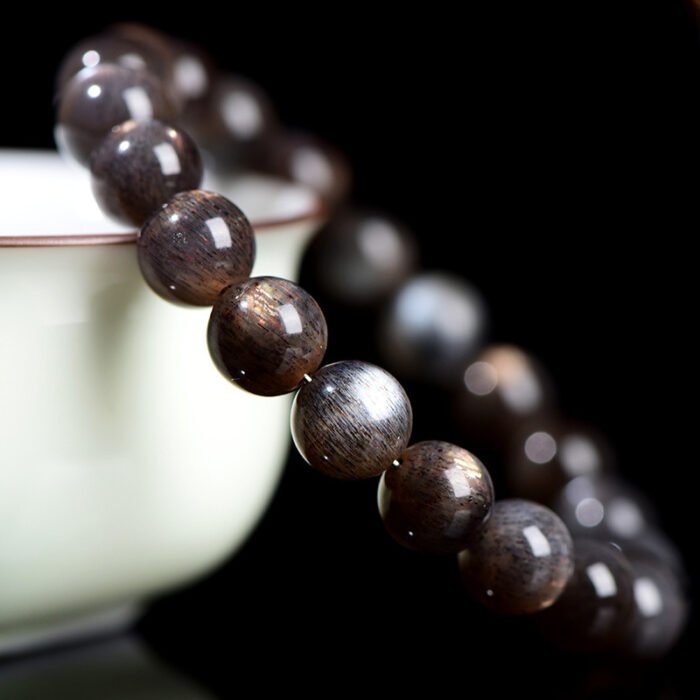 Black gold skeletal round bead crystal single-loop bracelet.